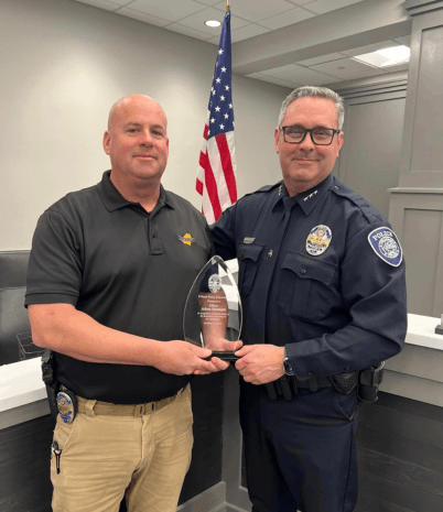 Pelham Police Detective Adam Schniper receives an award from Chief Brent Sugg.